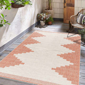 Outdoor patio scene with a Djugun Peach Fuzz area rug, geometric pattern, beige and terracotta colors. Roomscene-Rectangle