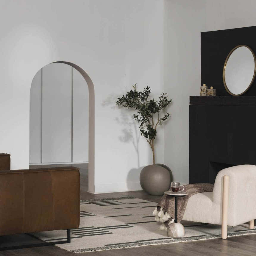 Living room with brown couch and Aibonito Hand Tufted Wool Area Rug in beige and black, creating a modern, neutral space. Roomscene-Rectangle