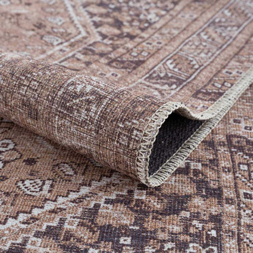 Close-up of the Barny Brown Flat Pile Washable Rug, showcasing its traditional brown, cream, and gray pattern and chenille texture. Fold