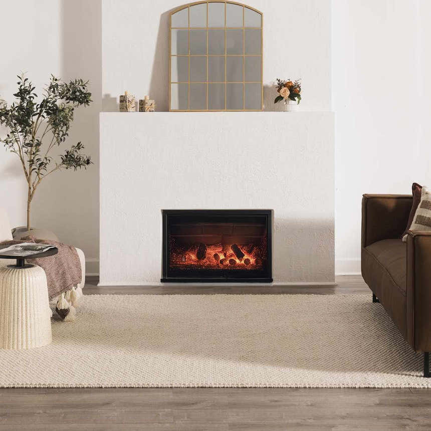 Living room scene with a cream Lucerne Plain Wool Rug, fireplace, brown sofa, and neutral decor. Roomscene-Rectangle