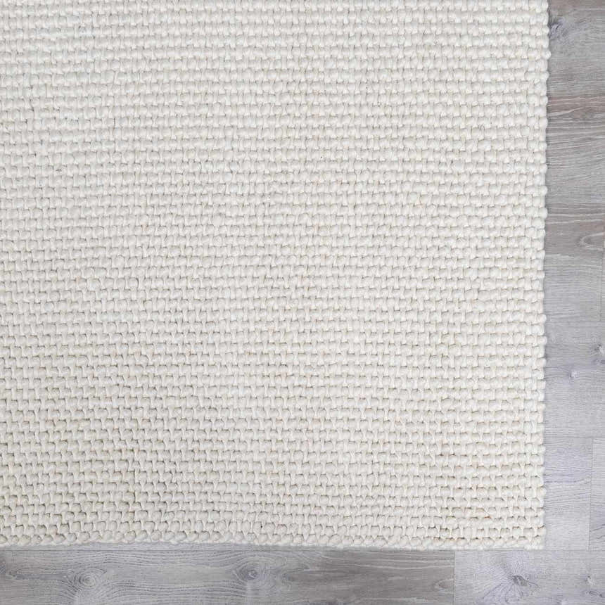 Close-up of the hand woven Lucerne Plain Cream Wool Rug showing texture and color. Swatch