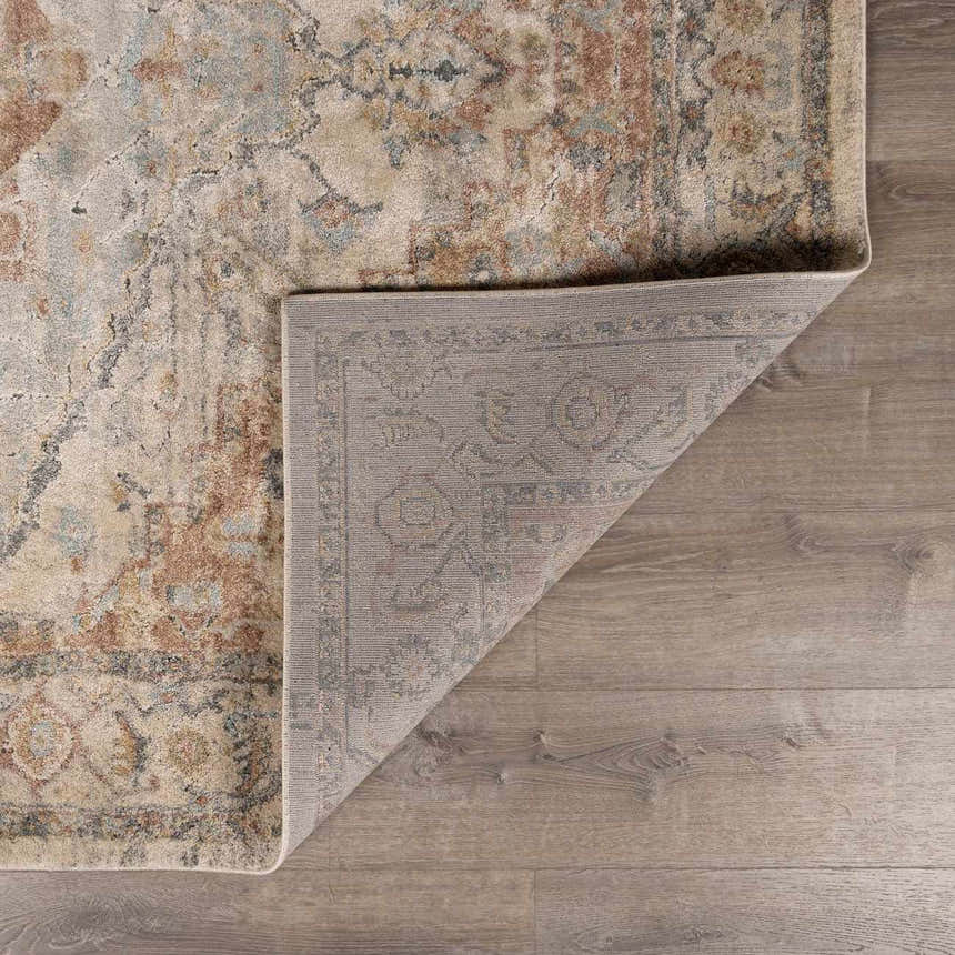 Close-up of the Vaeda Blue & Beige Thick Luxe Rug showing its traditional pattern, texture, and backing. Fold