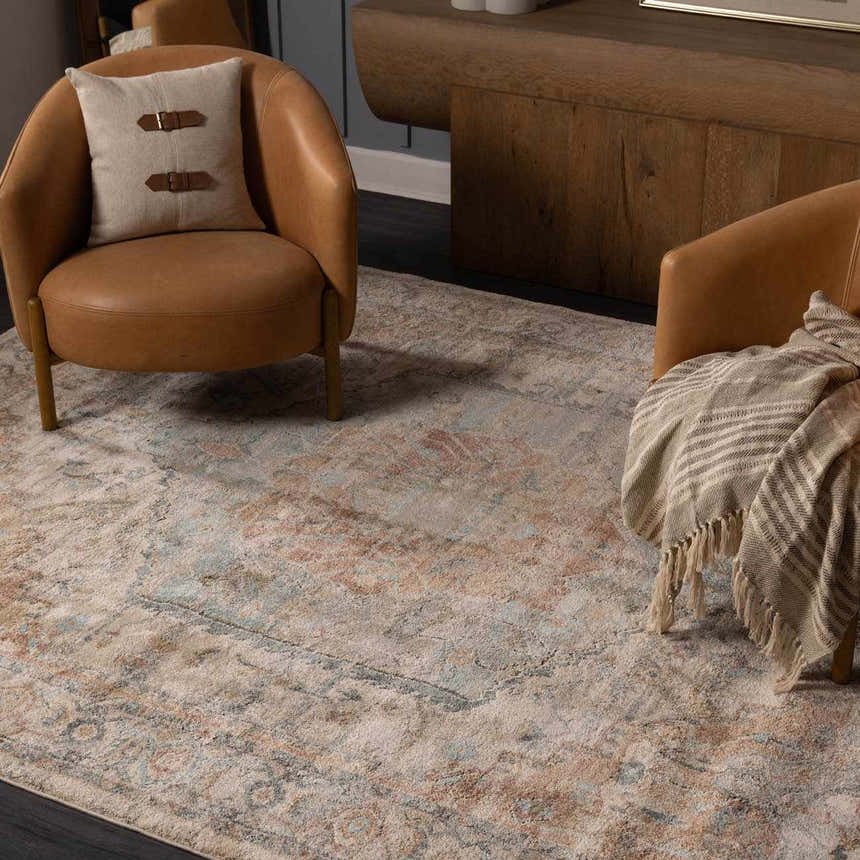 Living room scene with tan leather chairs and the Vaeda Blue & Beige rug. The rug has a traditional, distressed pattern. Roomscene-Rectangle