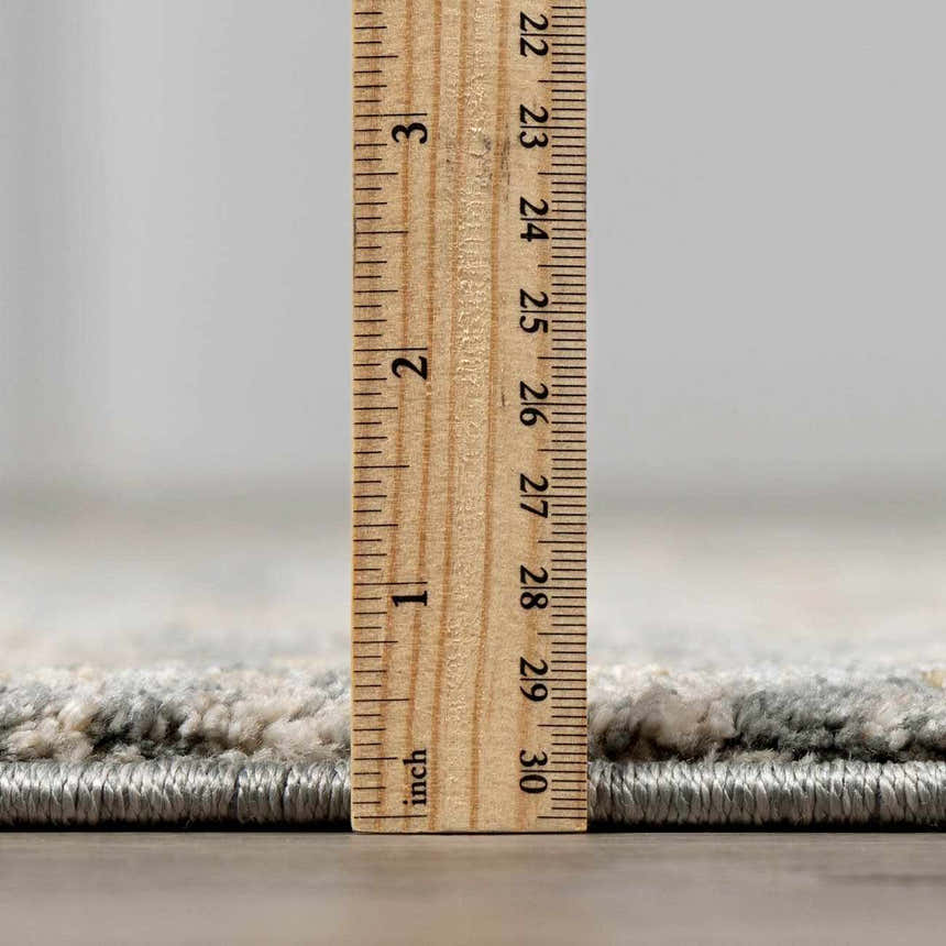 Close-up of the Vaeda Blue Thick Luxe Rug showing its plush pile height with a ruler. Pile
