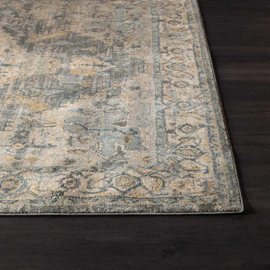 Close-up of the Vaeda Blue Thick Luxe Rug showing its beige, gray, and pale blue traditional pattern and soft texture. Corner