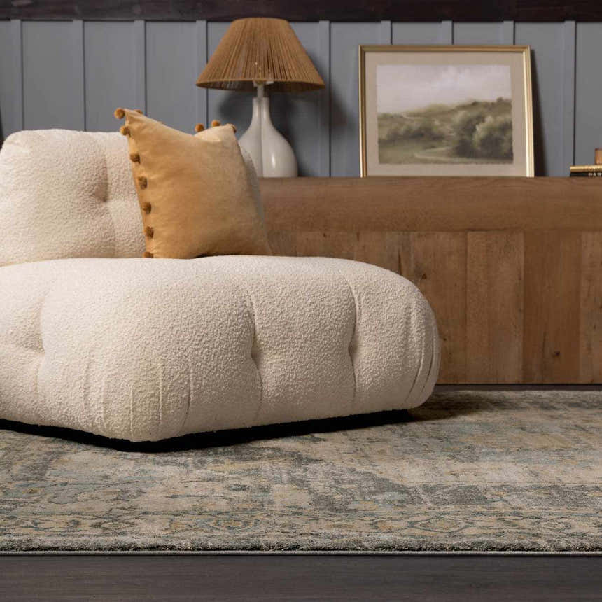 Living room scene with a Vaeda Blue Thick Luxe Rug, cream boucle sofa, and wood accents. Styleshot