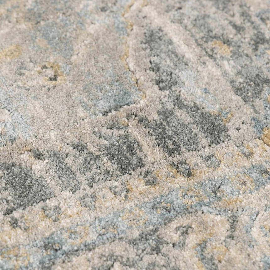 Close-up of the Vaeda Blue Thick Luxe Rug showing its plush texture and beige, gray, and pale blue abstract pattern. Texture