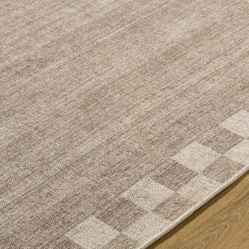 Close-up of the Bardot Washable Area Rug, showing a hand-woven texture and subtle checkerboard pattern in neutral tones. Texture