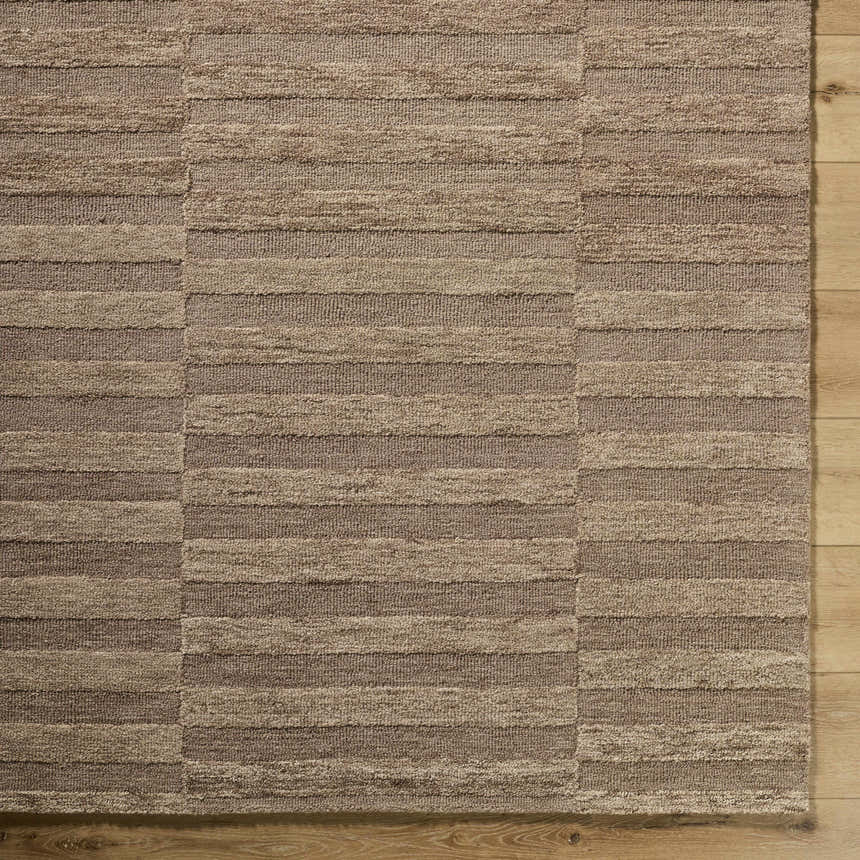 Close-up of the hand-tufted Idaho Broken-Striped Brown Area Rug. Beige, sandstone, and taupe wool stripes create a contemporary design. Corner