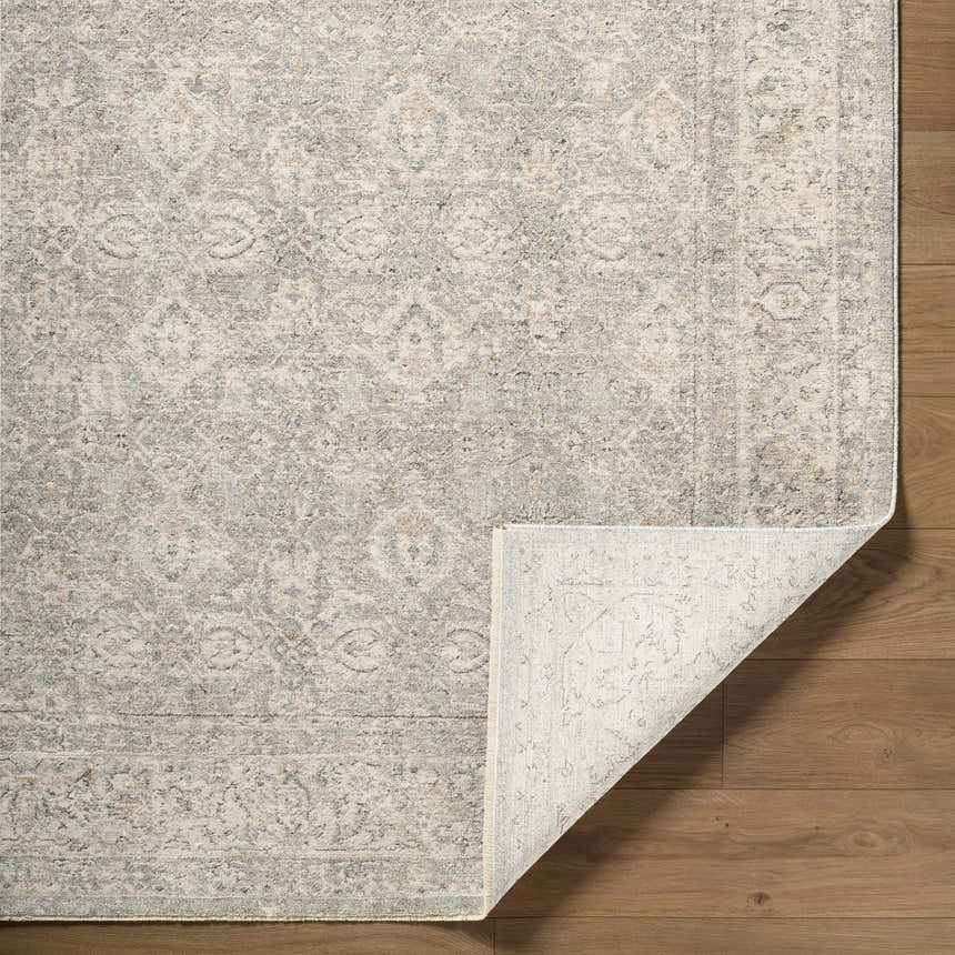 Close-up of the Buddug Cream Area Rug showing its farmhouse traditional pattern and polyester texture. Fold