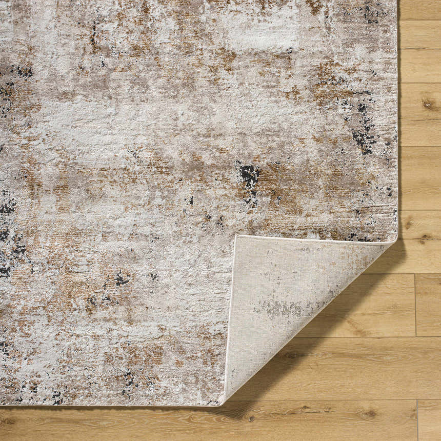 Close up of Weeko Luxe Thick Area Rug showing ivory, tan, and black abstract design and machine woven construction. Fold