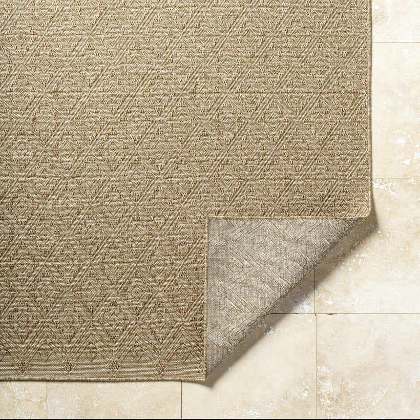 Close-up of the Bandit Brown Area Rug showing its camel color, geometric pattern, and textured, machine-woven construction. Fold
