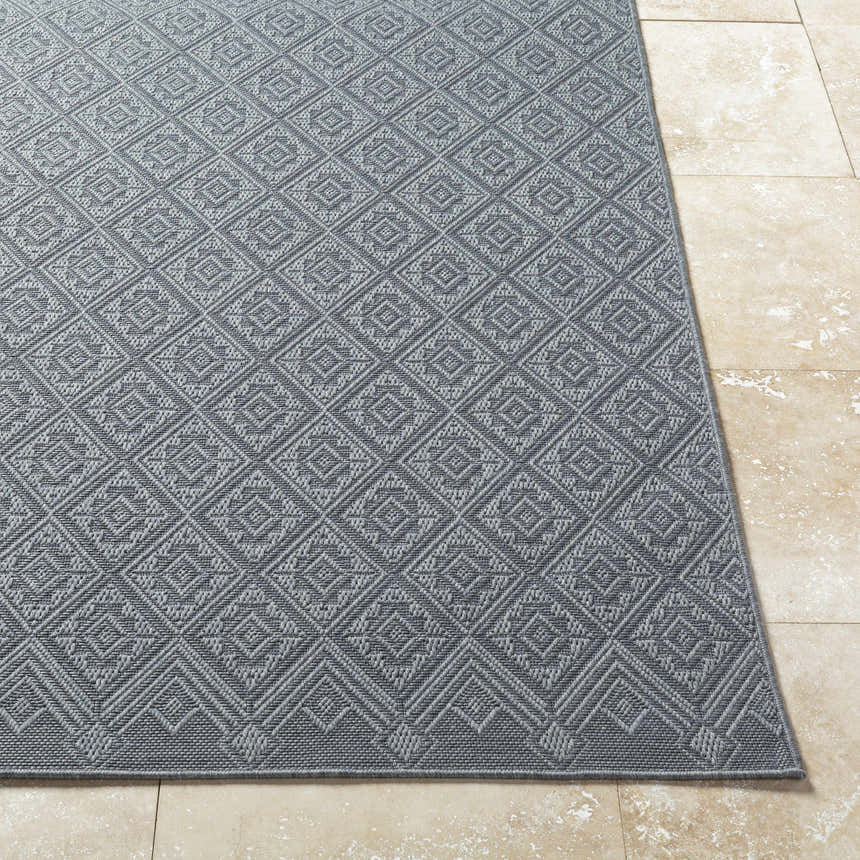 Close-up of the Bandit Gray Area Rug showing a diamond pattern and textured weave on a beige tile floor. Front