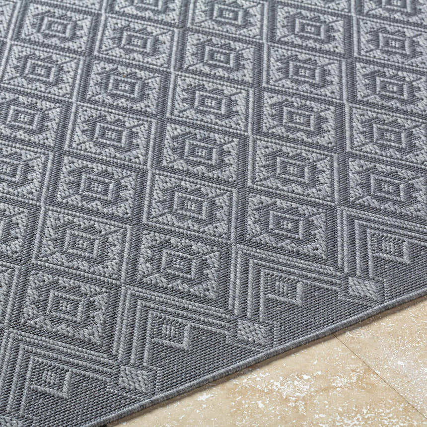 Close-up of the Bandit Gray Area Rug showing a geometric diamond pattern and woven texture. Texture