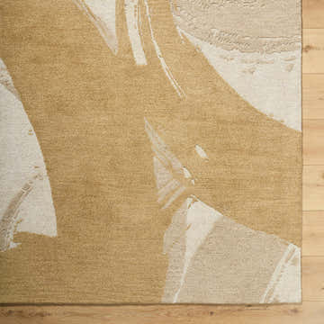 Close-up of the hand-tufted Bikita Area Rug. Features a contemporary abstract design in tan and cream wool. Swatch