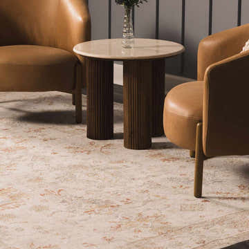 Living room scene with tan leather chairs and a Beausejour Oushak rug in beige and rust tones. Roomscene-Rectangle