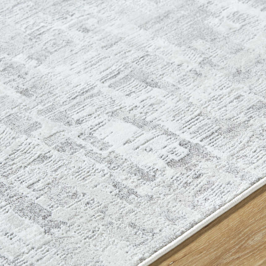 Close up of the Branka Area Rug, showing a contemporary light silver and gray pattern. Texture