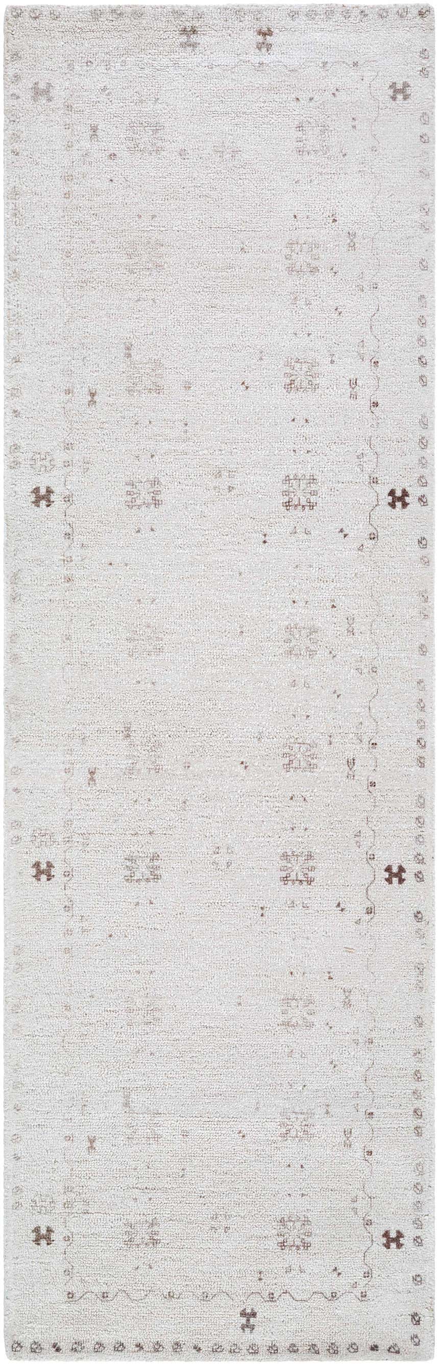 Close-up of the hand-tufted Bhavna Area Rug. Ivory rug with a subtle sandstone and taupe traditional pattern. Design-Runner-268