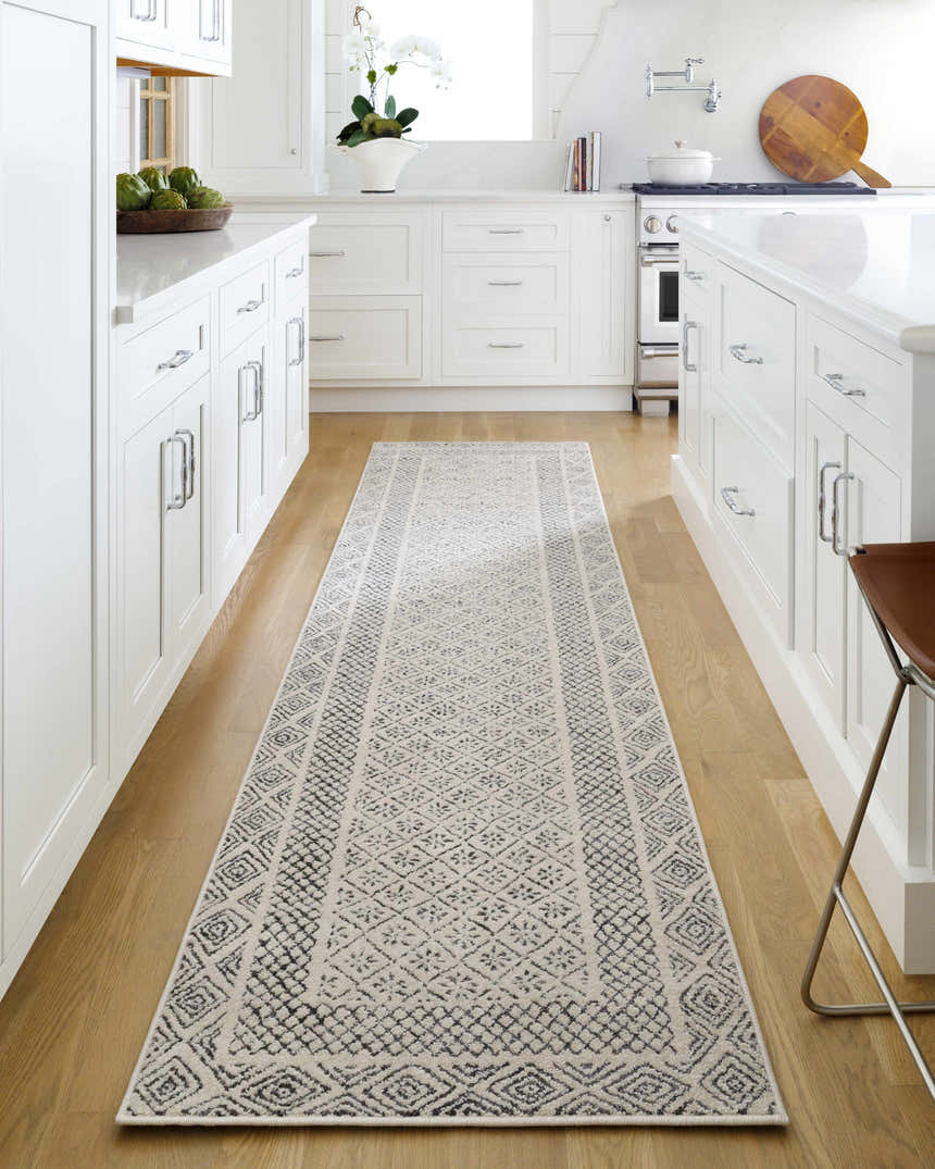 Farmhouse kitchen with white cabinets and wood floors featuring Livabliss Bahar charcoal and off white runner rug. Roomscene-Runner