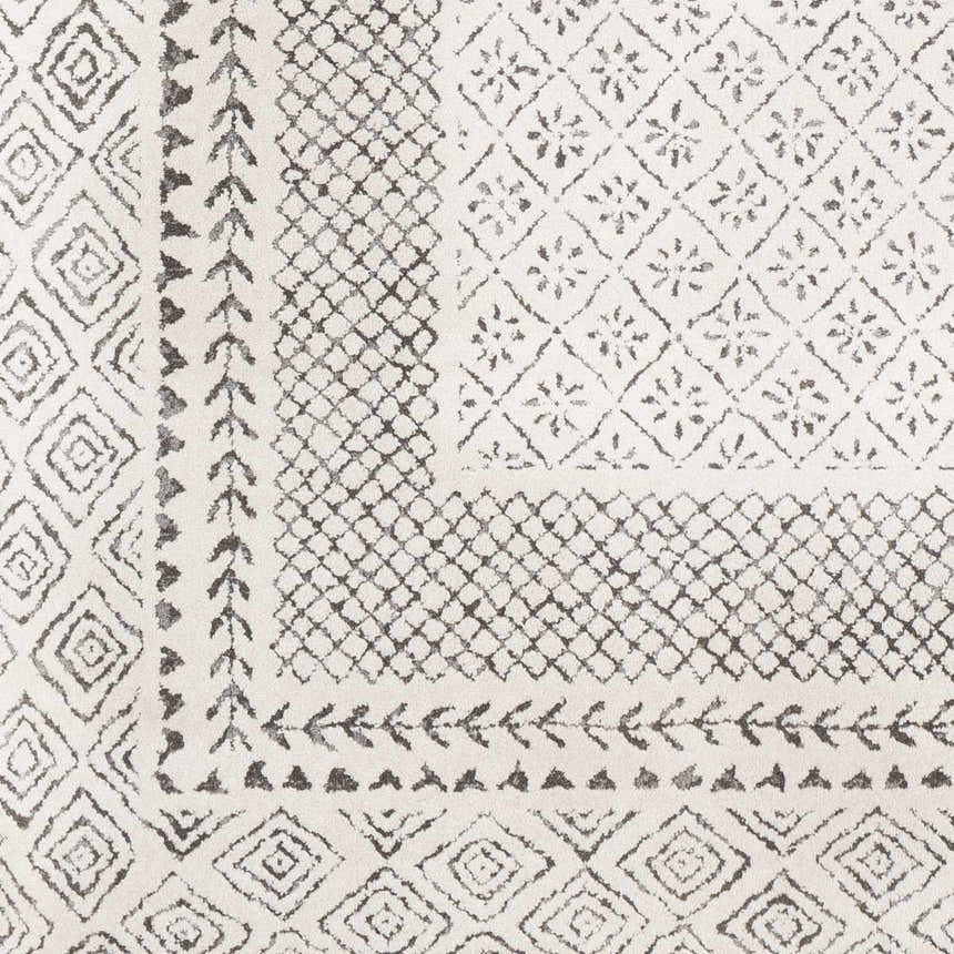Close-up of the Livabliss Bahar BHR-2321 area rug. Features a charcoal and off-white geometric pattern and machine woven texture. Swatch
