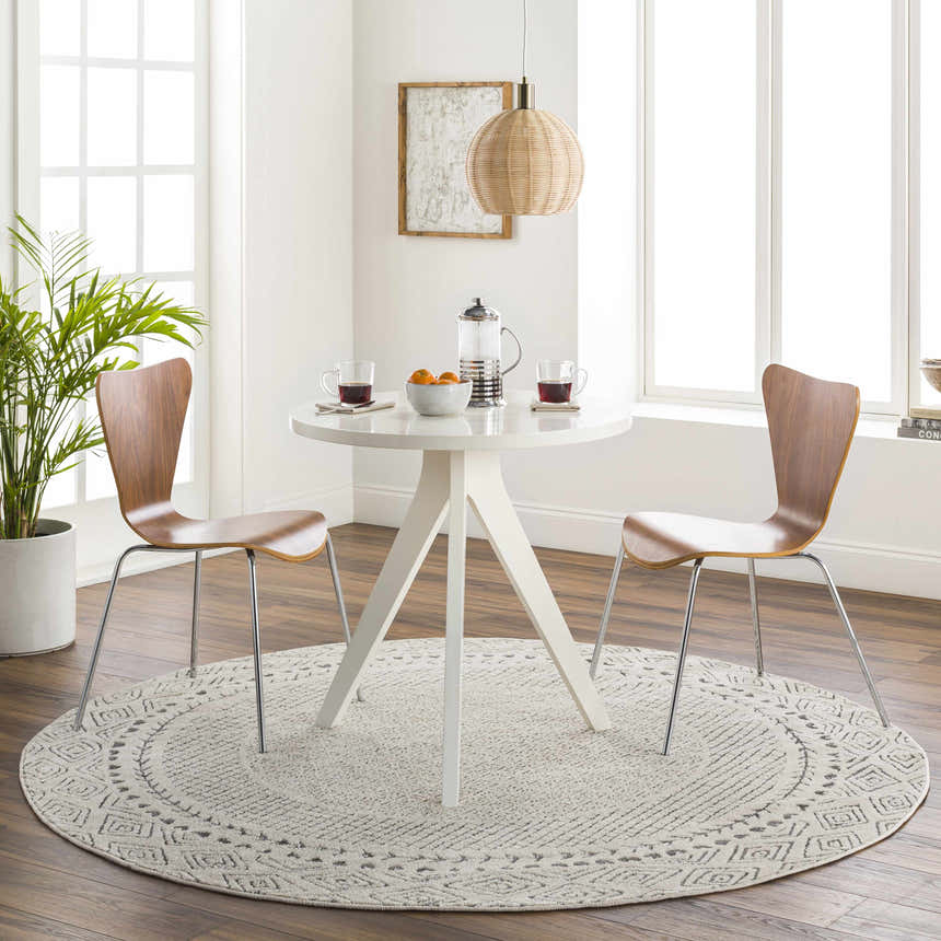 Bright dining room with round white table and Livabliss Bahar BHR-2321 area rug in charcoal and off white. Roomscene-Round