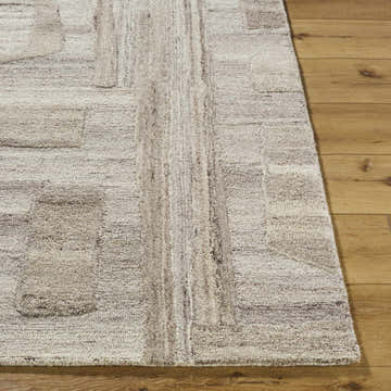 Close up of the Brasen Beige Area Rug showing its hand tufted wool texture and geometric pattern. Front
