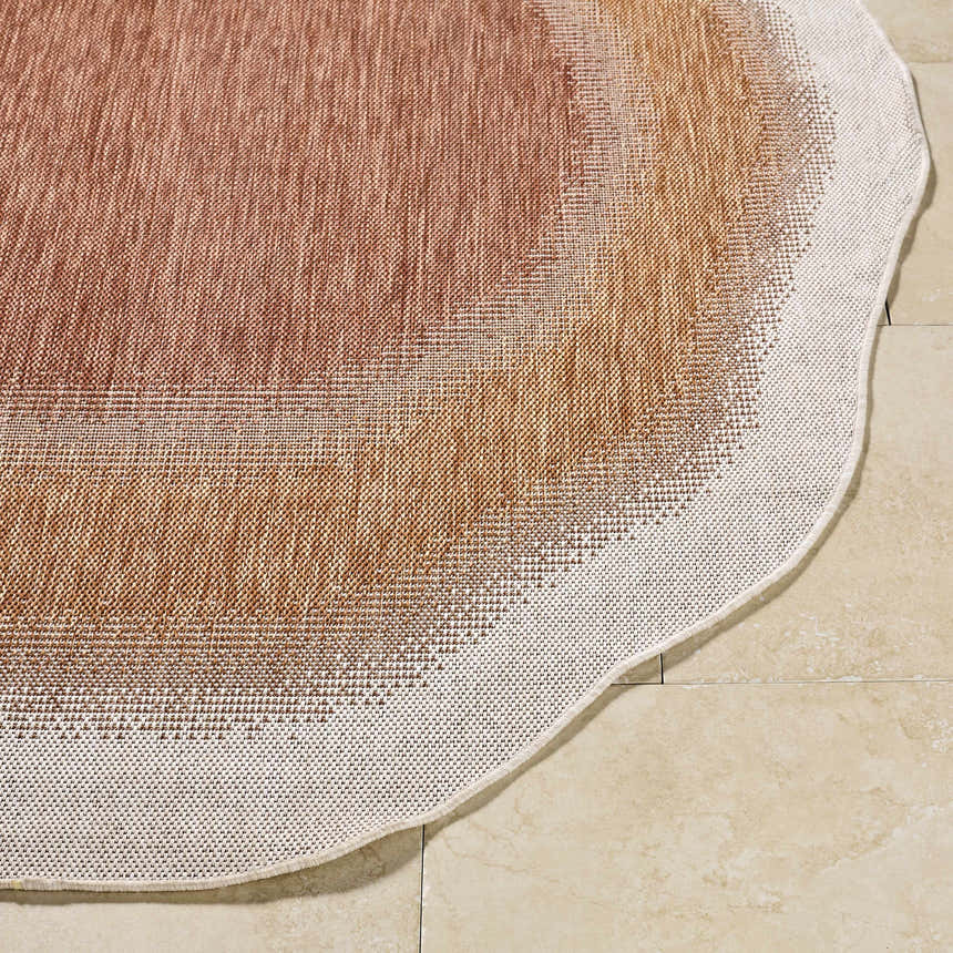 Close-up of the Burian Orange Area Rug showing burnt orange, cream, and rust tones. Machine woven texture. Front
