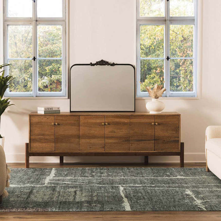 Living room scene with a gray Janek II Modern Abstract Area Rug, wood console table, and large mirror. Roomscene-Rectangle