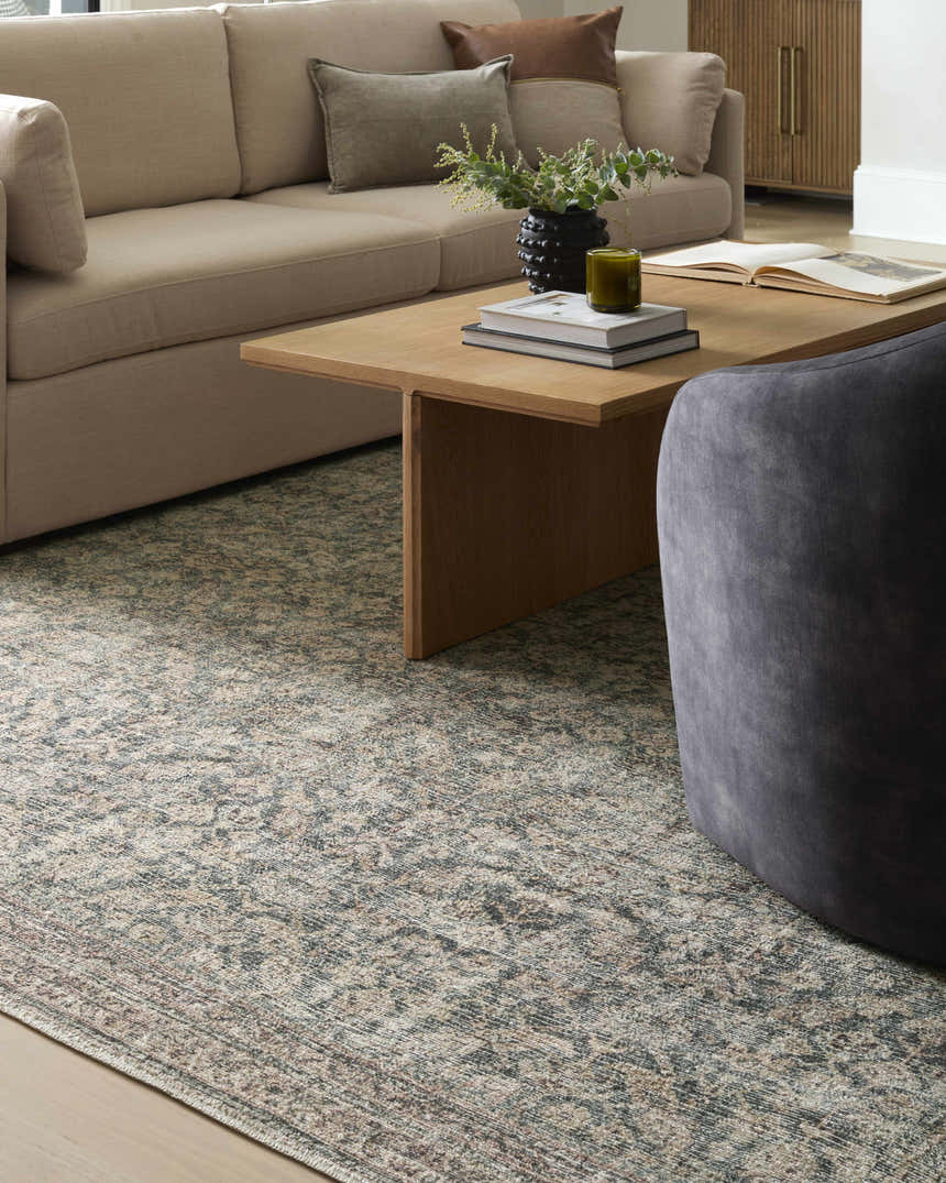 Living room scene with a beige sofa and the Collins Avenue III Vintage Damask Area Rug in beige, red, and green. Styleshot