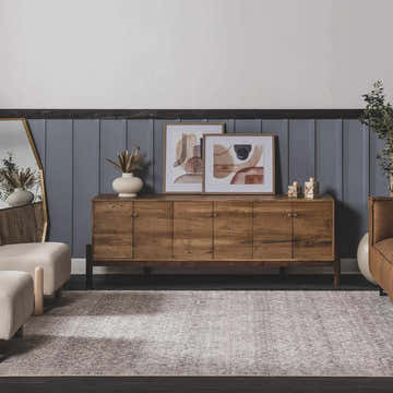 Living room scene with a Collins Avenue IV Vintage Damask Area Rug, wood cabinet, neutral armchair, and gray wall. Roomscene-Rectangle