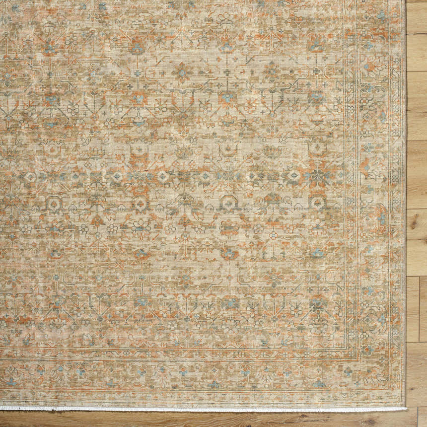 Close-up of the Becki Denim Owens x Livabliss Renaissance Area Rug. Beige, denim, coral, and tan farmhouse-style wool rug. Corner