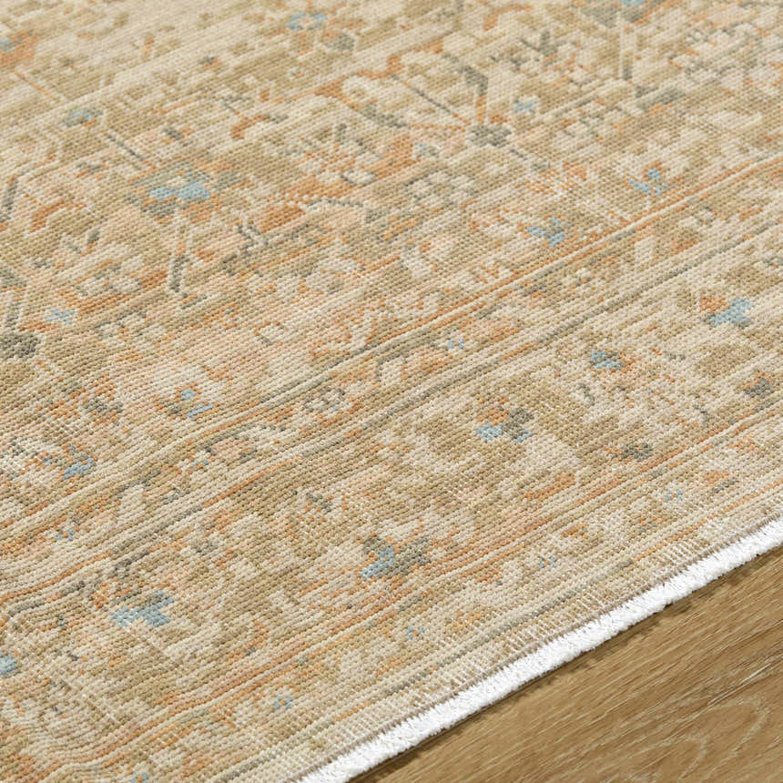 Close-up of the hand-crafted Becki Denim Owens x Livabliss Renaissance Area Rug. Beige, denim, coral, and tan wool rug. Texture
