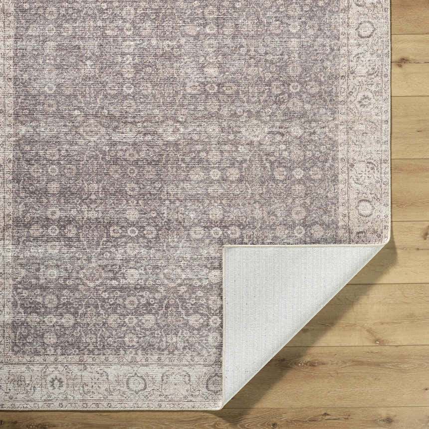 Close-up of the Spokane Dark Brown Area Rug. Farmhouse style rug with cream, dark brown, dark red, and peach floral pattern. Fold