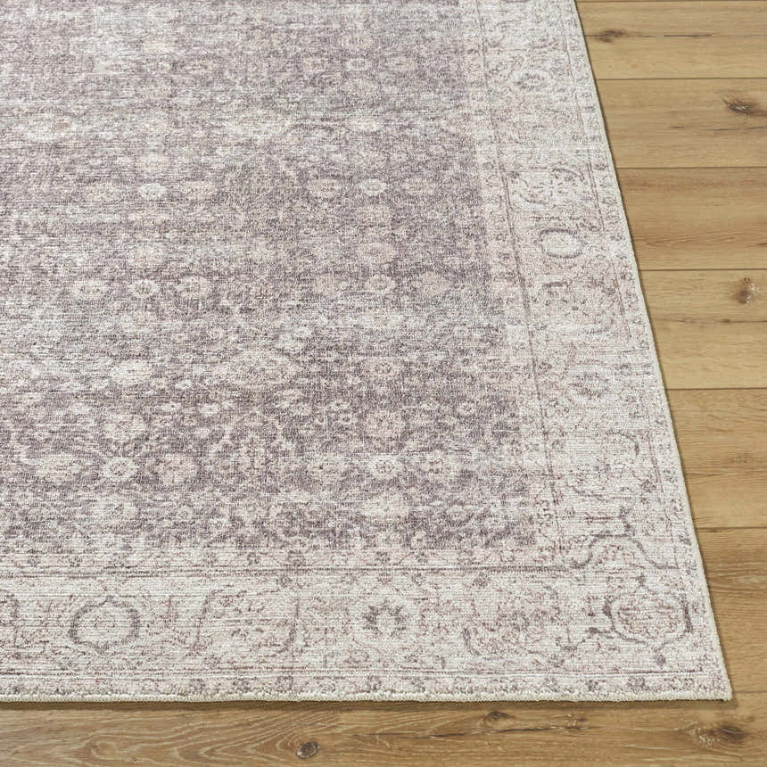 Close-up of the Spokane Dark Brown Area Rug showing its traditional cream and dark brown floral pattern and soft texture. Front