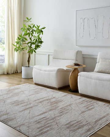 Living room scene with two white chairs and the Utari Cream Area Rug with a subtle geometric pattern. Roomscene-Rectangle