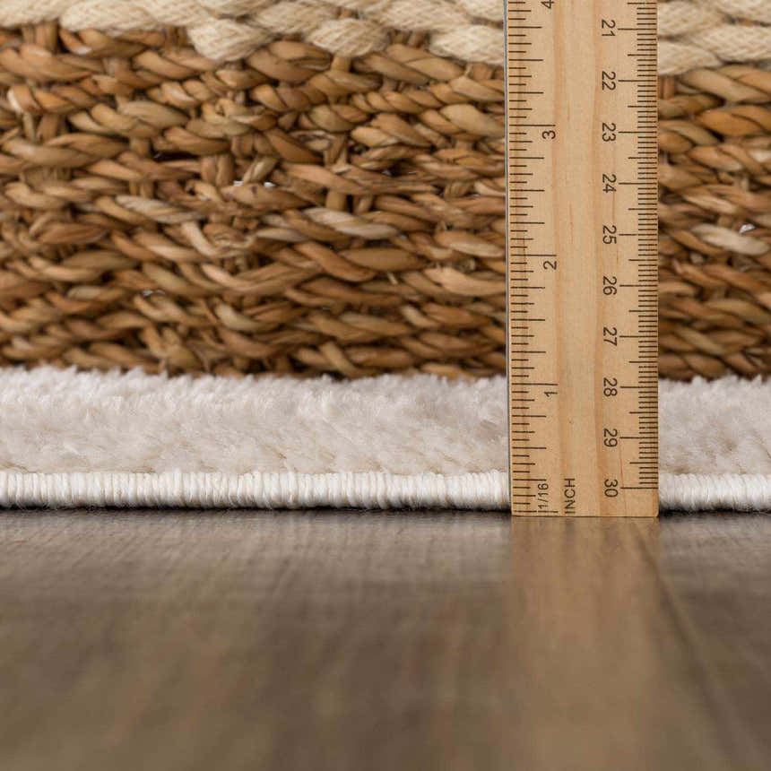 Close-up of the Baback Beige Washable Area Rug showing the pile height and woven texture with a ruler for scale. Pile