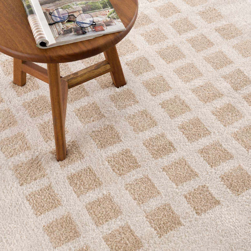Close up of the Baback Beige Washable Area Rug featuring a geometric square pattern in beige and cream. Styleshot