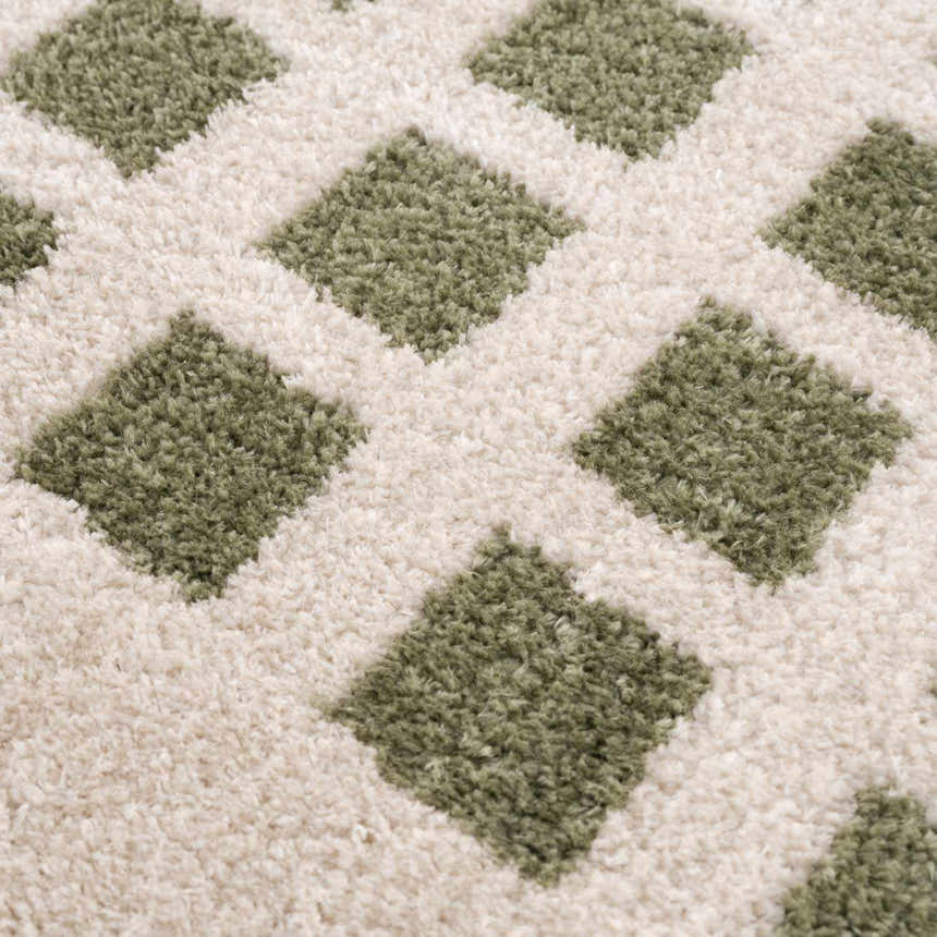 Close-up of the Baback Green Washable Area Rug, showing a lime green diamond pattern on a cream-colored, textured background. Texture