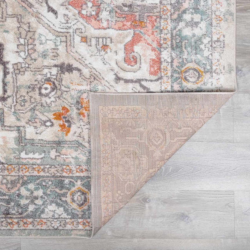 Close-up of the Bolinas Area Rug showing its brick red, camel, and charcoal oriental pattern and machine-woven texture. Fold