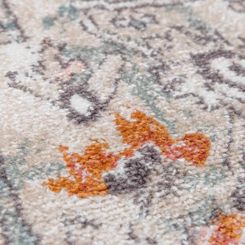 Close-up of the Bolinas Area Rug showing brick red, camel, and charcoal colors in a traditional, machine-woven pattern. Texture