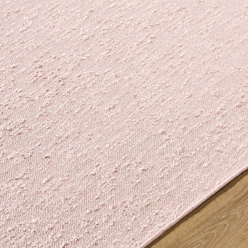 Close-up of the hand woven Breena Blush Washable Area Rug showing texture and color. Texture