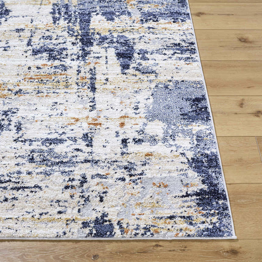 Close-up of the Bazyli Area Rug. Contemporary design with ivory, light gray, navy, peach, and white colors. Front
