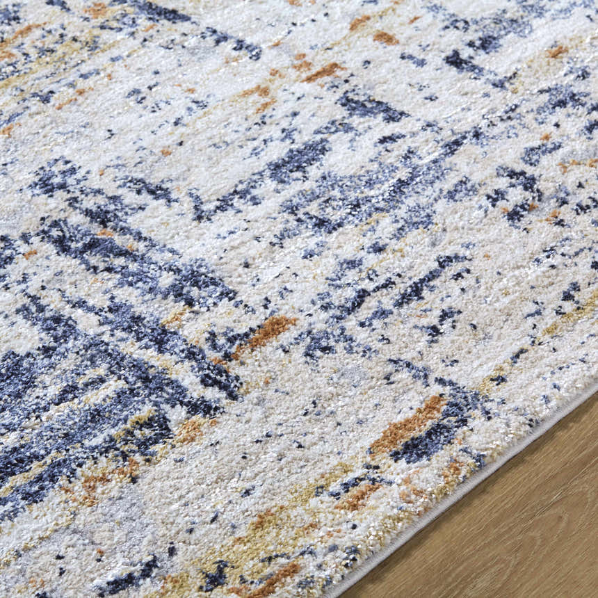Close-up of the Bazyli Area Rug, showcasing its ivory, light gray, navy, and peach contemporary pattern. Texture