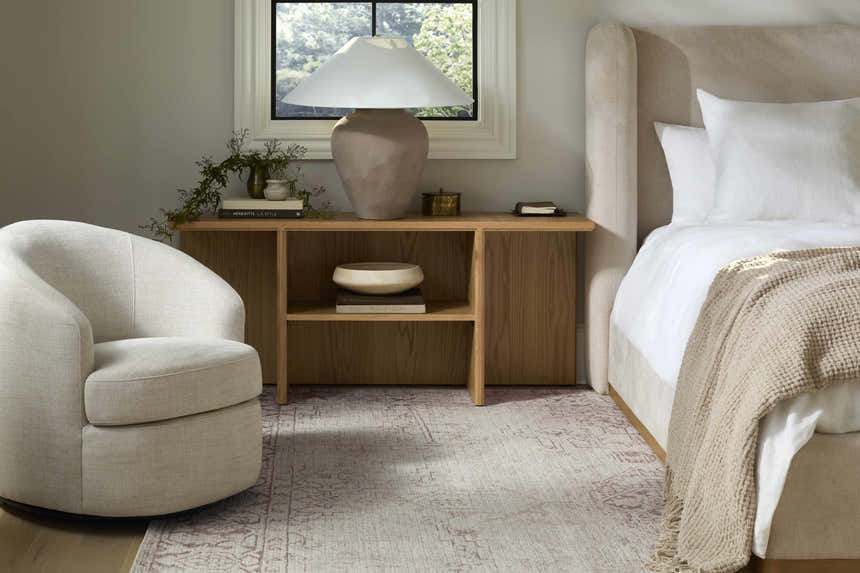 Bedroom scene with Galey Alix Collins Avenue V Vintage Medallion Rug in beige, red, and gray. Neutral tones, cozy reading nook. Roomscene-Rectangle