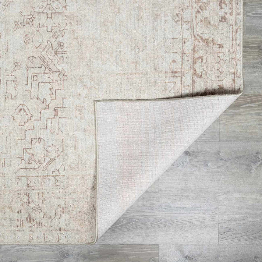 Close-up of the Galey Alix Collins Avenue V Vintage Medallion Rug. Beige, dark red, and ivory vintage pattern detail. Fold
