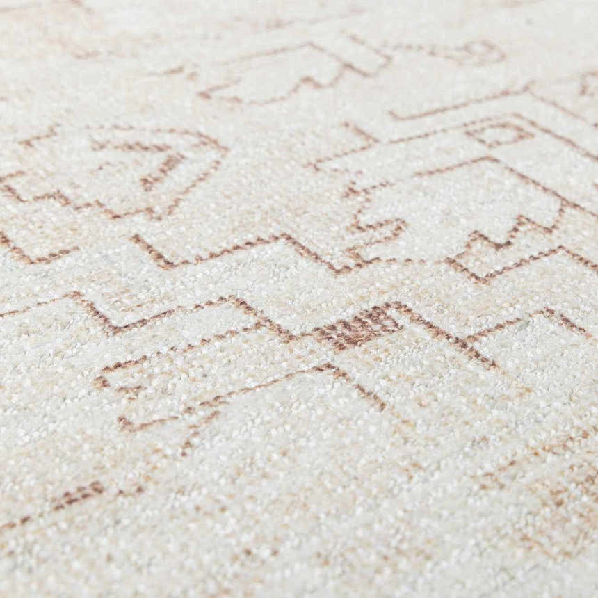 Close-up of Galey Alix Collins Avenue V Vintage Medallion Rug. Beige rug with dark red geometric pattern and soft texture. Texture