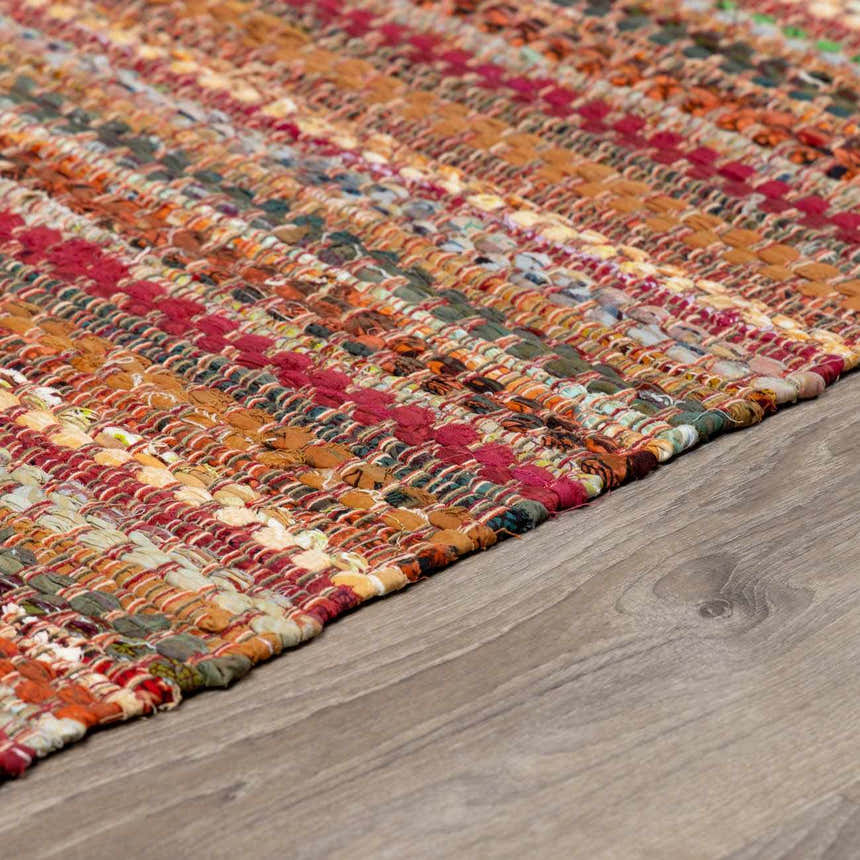 Close-up of the hand woven Brenda Crimson Area Rug. Farmhouse style rug with red, orange, and green tones. Pile