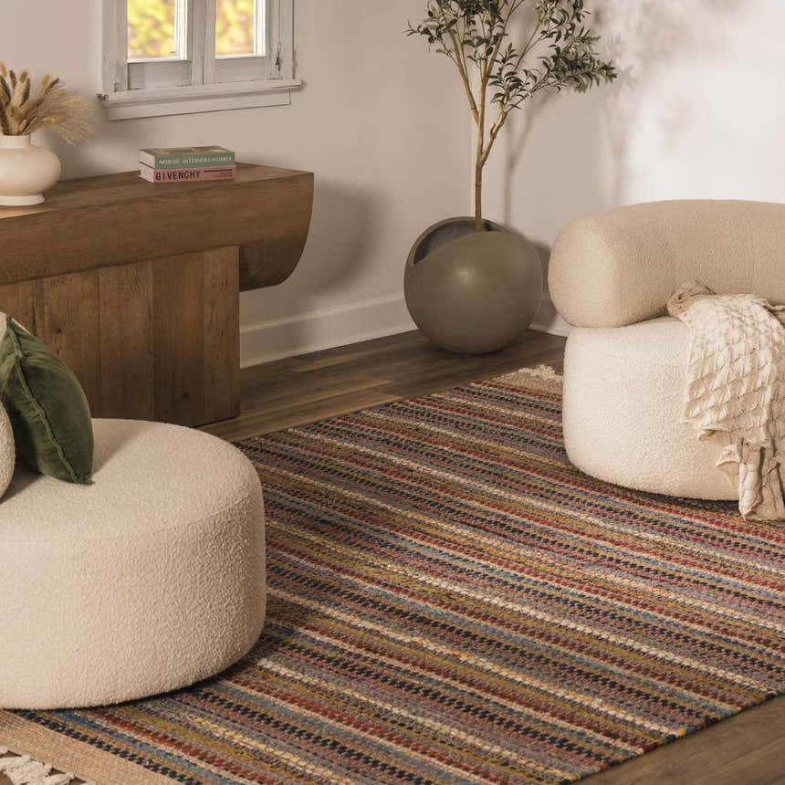 Living room scene with a colorful striped Brenda Crimson Area Rug, cream poufs, wood console table, and potted olive tree. Roomscene-Rectangle