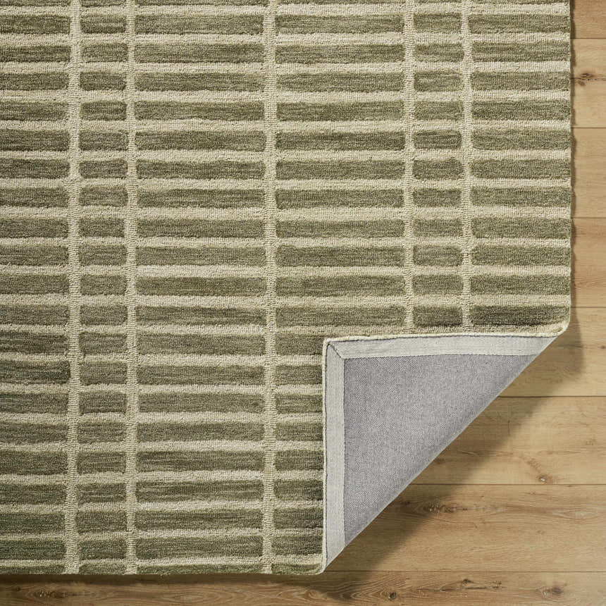 Close-up of the Bendek Olive Area Rug showing its beige and olive rectangular pattern and wool texture. Fold