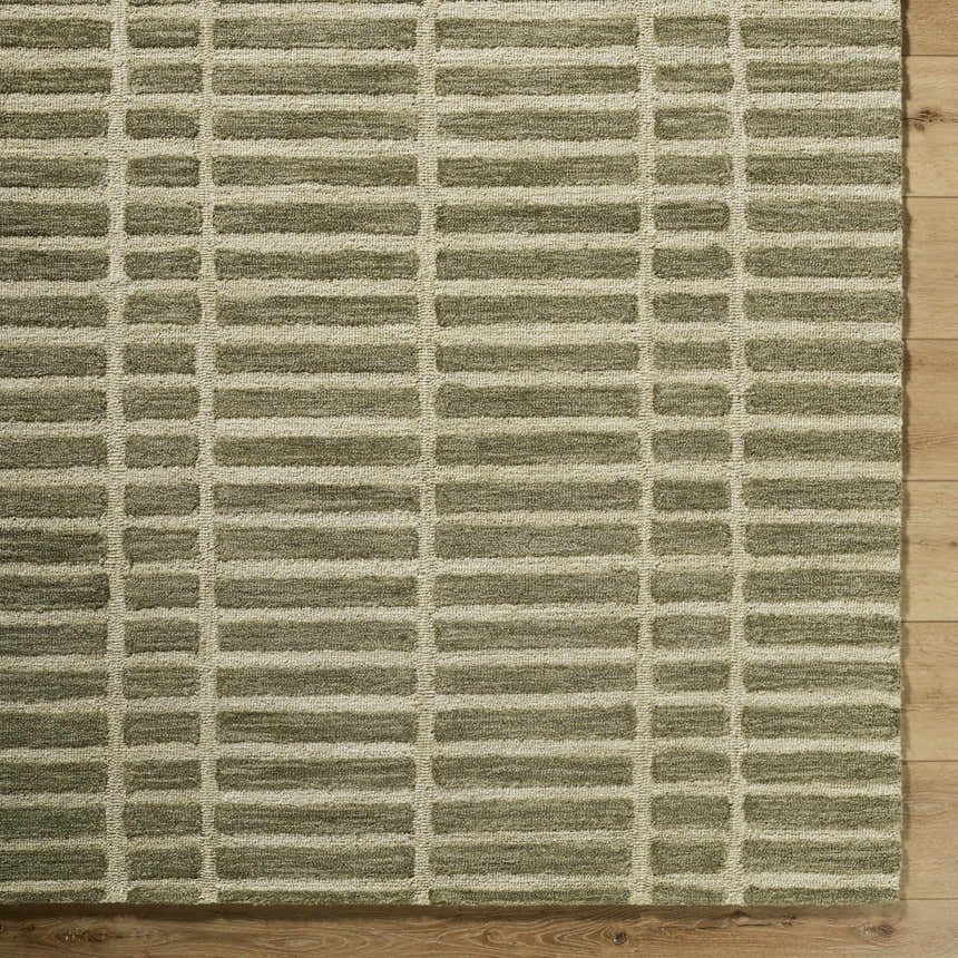Close-up of Bendek Olive Area Rug. Beige and olive wool rug with a contemporary rectangular pattern. Hand-tufted texture. Corner